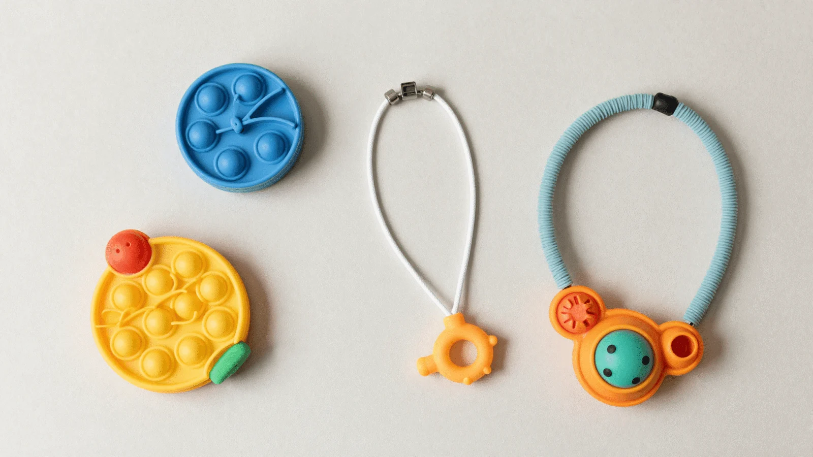 Calming sensory items: soft fidget toys and a chew necklace