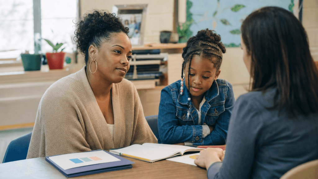Mother and daughter at a school support meeting with a teacher