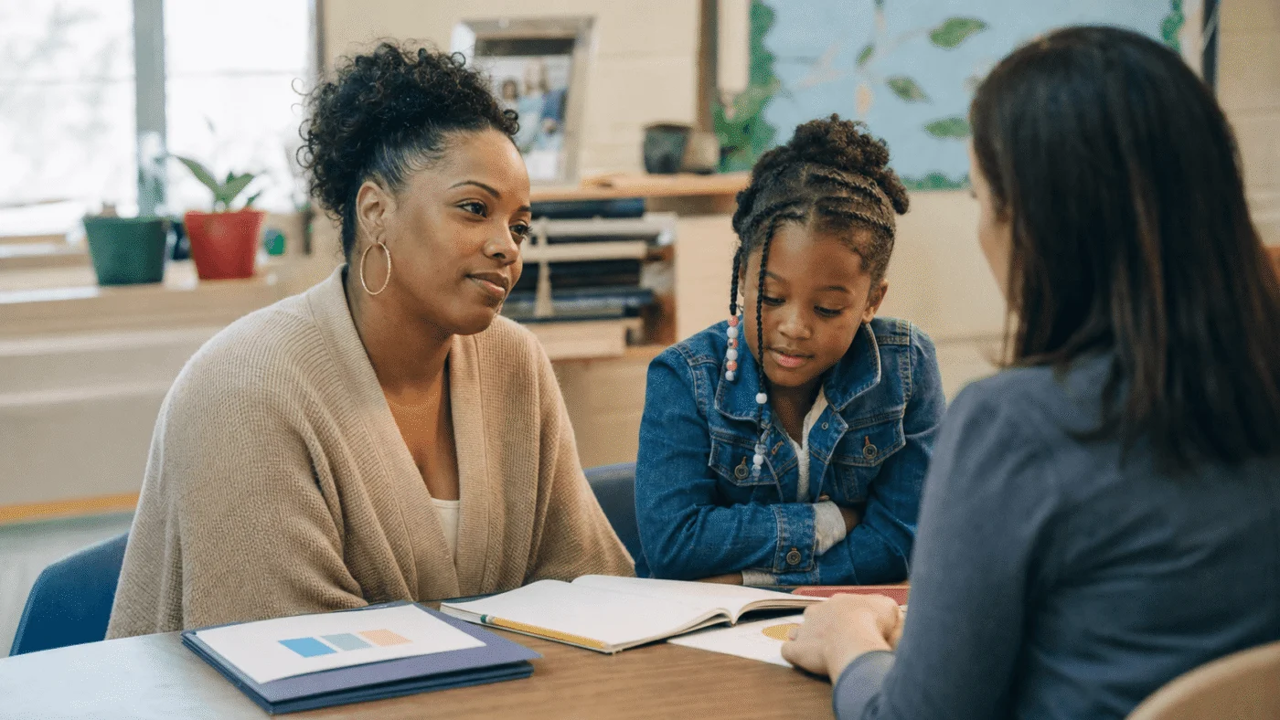 Mother and daughter at a school support meeting with a teacher