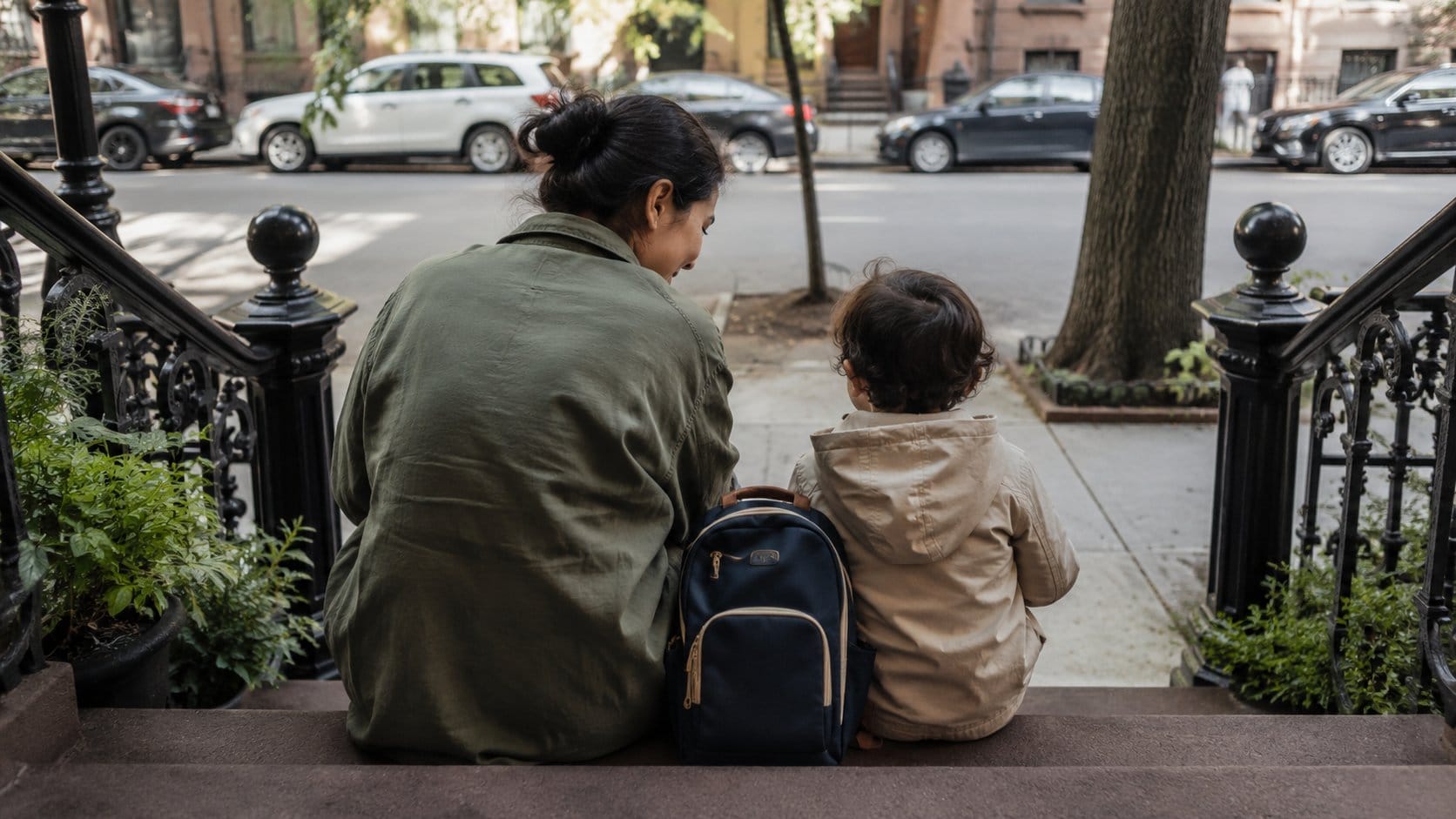 Mom toddler brownstone steps after school navy backpack street asian 16x9