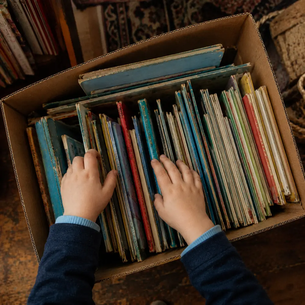 A cardboard box of second-hand children's books ready for a charity shop